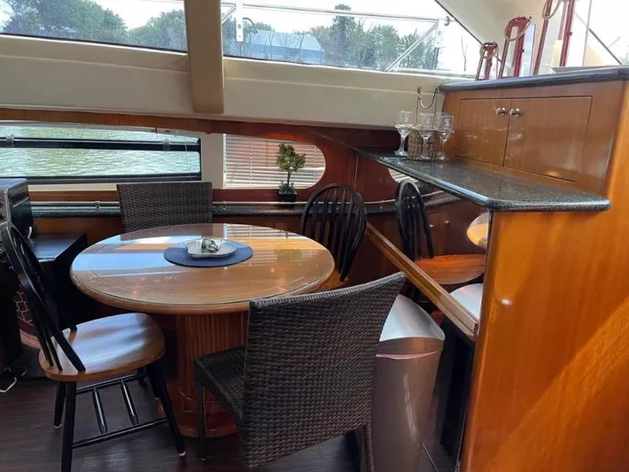  Yacht Photos Pics Interior of 2000 Carver 506 Motor Yacht with dining area and wooden furnishings.