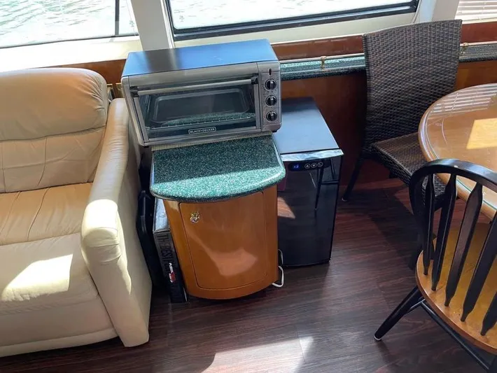  Yacht Photos Pics Interior of 2000 Carver 506 Motor Yacht with mini fridge, toaster oven, and seating area.