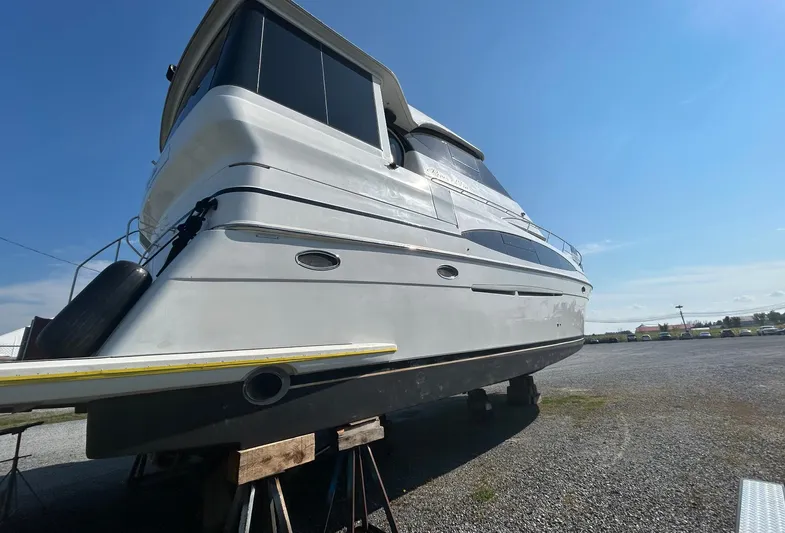  Yacht Photos Pics 2000 Carver 506 Motor Yacht on stands, side view under clear blue sky.