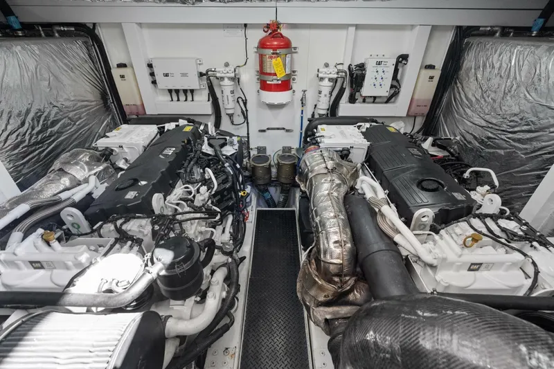 Above Deck Yacht Photos Pics Engine room of a 2018 Princess S60 yacht, featuring dual engines and fire safety equipment.