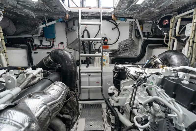 Above Deck Yacht Photos Pics Engine room of a 2018 Princess S60 yacht, featuring complex machinery and piping.