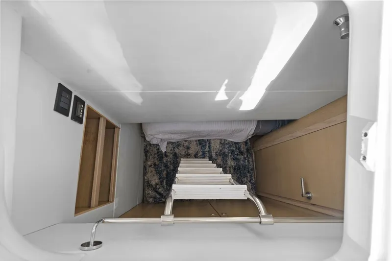 Above Deck Yacht Photos Pics Interior view of 2018 Princess S60 yacht, featuring a compact cabin with a ladder.