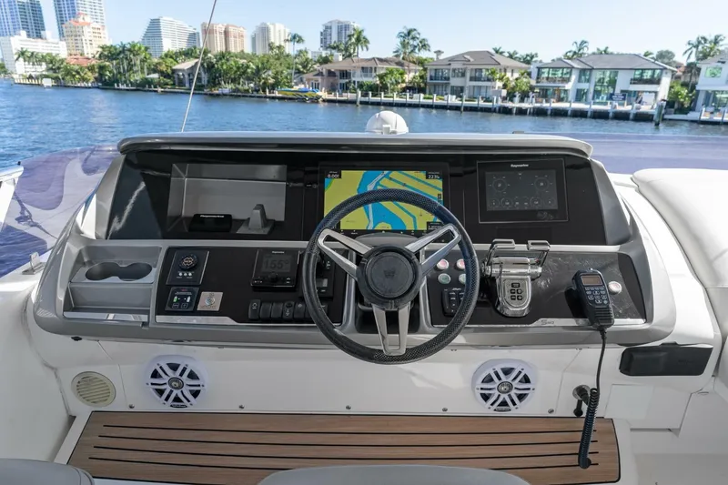 Above Deck Yacht Photos Pics Cockpit of 2018 Princess S60 yacht with navigation controls and waterfront view.