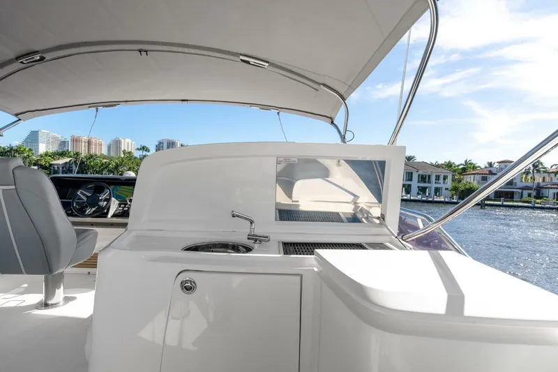 Above Deck Yacht Photos Pics Luxury yacht Princess S60 2018 with outdoor kitchen and scenic waterfront view.