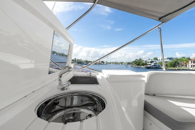 Above Deck Yacht Photos Pics Luxurious 2018 Princess S60 yacht interior with sink, overlooking serene waterfront view.