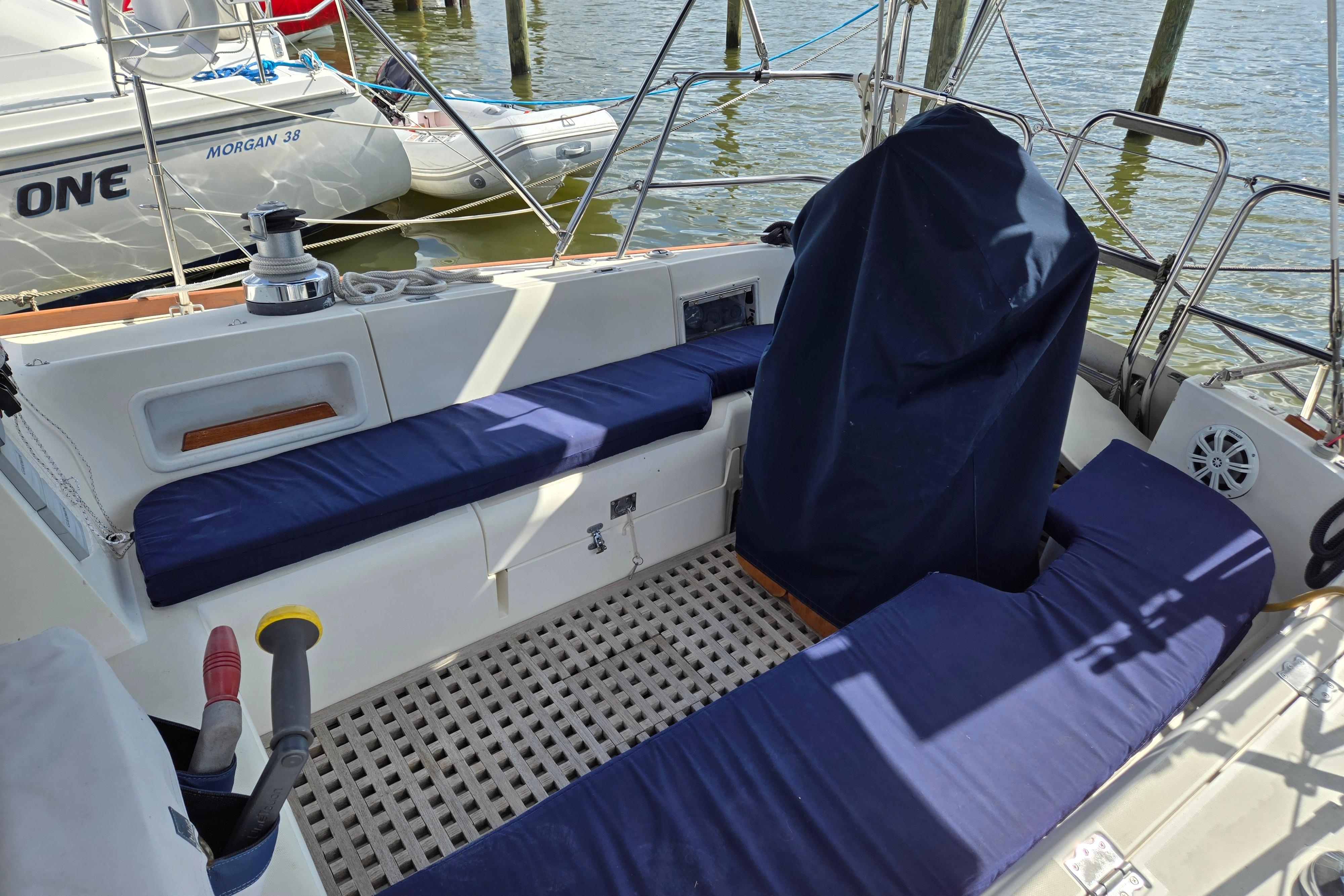 1989 Pearson 37-2 sailboat cockpit with blue cushions and covered helm at dock.