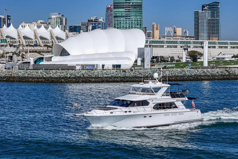 As Good As It Gets Yacht Photos Pics 2002 Ocean Alexander 640 Pilothouse yacht cruising near modern waterfront buildings.