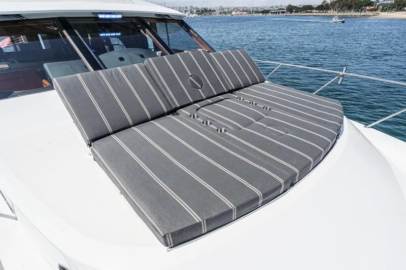 As Good As It Gets Yacht Photos Pics Sunbathing cushions on 2002 Ocean Alexander 640 Pilothouse yacht, overlooking serene waters.