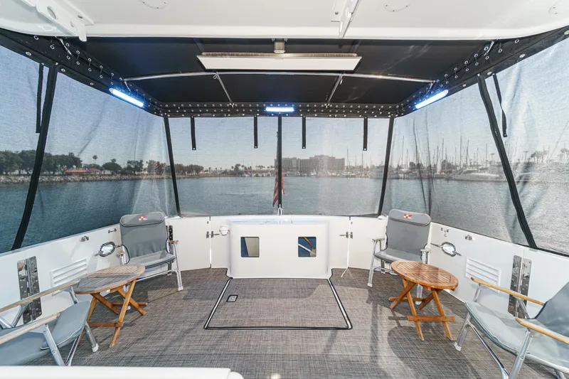 As Good As It Gets Yacht Photos Pics 2002 Ocean Alexander 640 Pilothouse aft deck with seating, tables, and marina view.