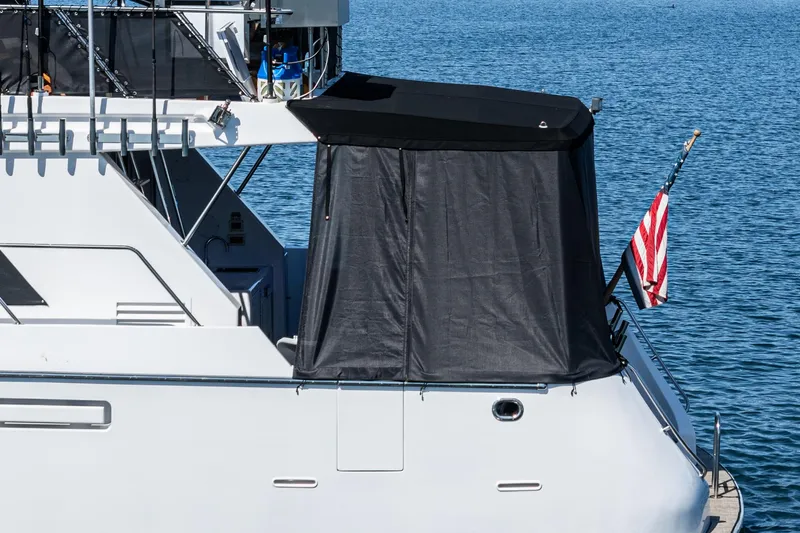 As Good As It Gets Yacht Photos Pics 2002 Ocean Alexander 640 Pilothouse yacht with American flag, docked on calm water.