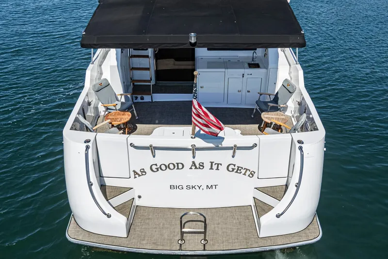 As Good As It Gets Yacht Photos Pics 2002 Ocean Alexander 640 Pilothouse yacht with seating, American flag, and "As Good As It Gets" text.