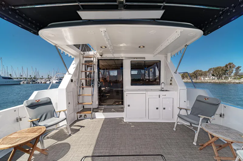 As Good As It Gets Yacht Photos Pics Luxurious 2002 Ocean Alexander 640 Pilothouse yacht deck with seating and marina view.