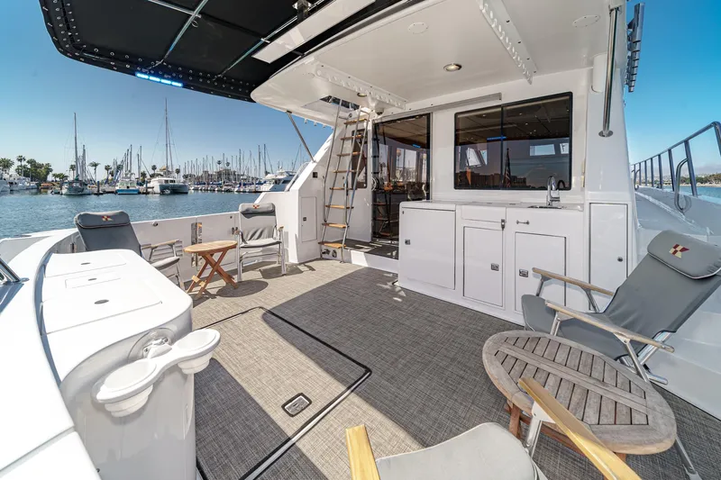 As Good As It Gets Yacht Photos Pics Luxurious 2002 Ocean Alexander 640 Pilothouse yacht deck with seating and marina view.