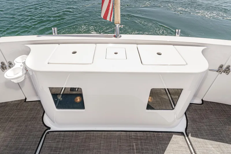 As Good As It Gets Yacht Photos Pics Ocean Alexander 640 Pilothouse 2002 yacht deck with storage compartments and American flag.
