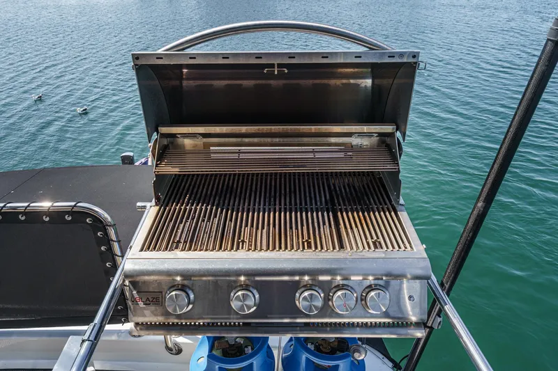 As Good As It Gets Yacht Photos Pics Stainless steel grill on Ocean Alexander 640 Pilothouse yacht, 2002, overlooking serene water.