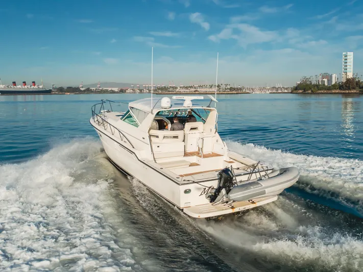 Miss Michelle Yacht Photos Pics 1996 Tiara Yachts 4300 cruising on a sunny day, leaving a wake behind.
