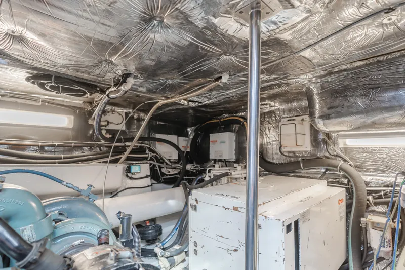 Miss Michelle Yacht Photos Pics Engine room of a 1996 Tiara Yachts 4300, showcasing machinery and wiring.