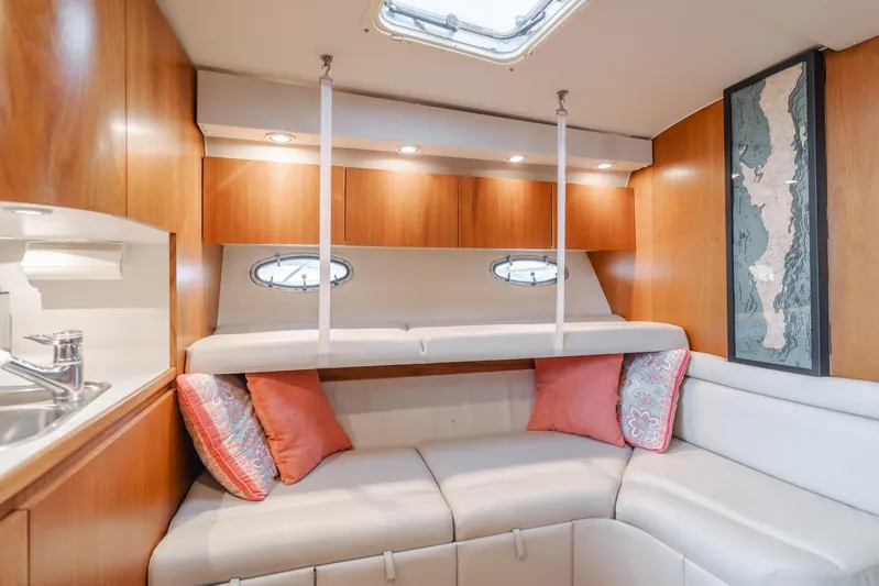 Miss Michelle Yacht Photos Pics Luxurious interior of 1996 Tiara Yachts 4300 with cozy seating and elegant wood finish.