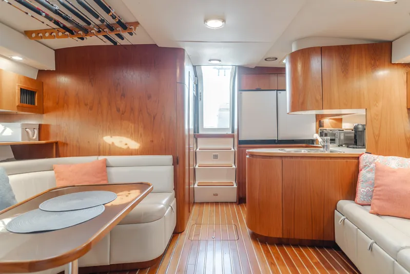 Miss Michelle Yacht Photos Pics Interior of a 1996 Tiara Yachts 4300, featuring wood finishes and cozy seating.