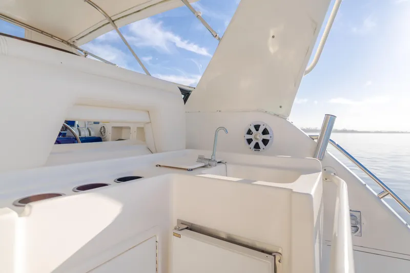 Miss Michelle Yacht Photos Pics 1996 Tiara Yachts 4300 interior with sink and storage, under sunny sky.