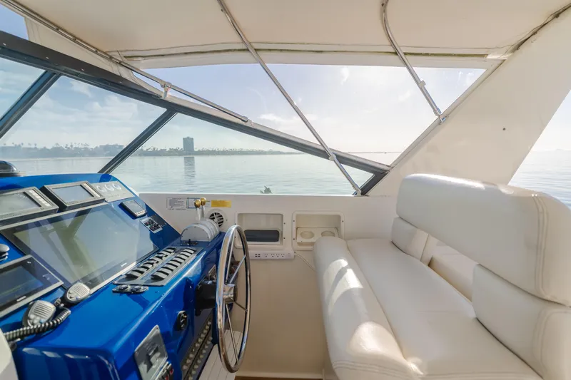 Miss Michelle Yacht Photos Pics Interior view of 1996 Tiara Yachts 4300, featuring helm and seating area.