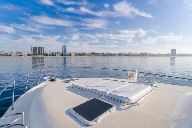 Miss Michelle Yacht Photos Pics Tiara Yachts 4300, 1996 model, cruising on calm waters with city skyline view.