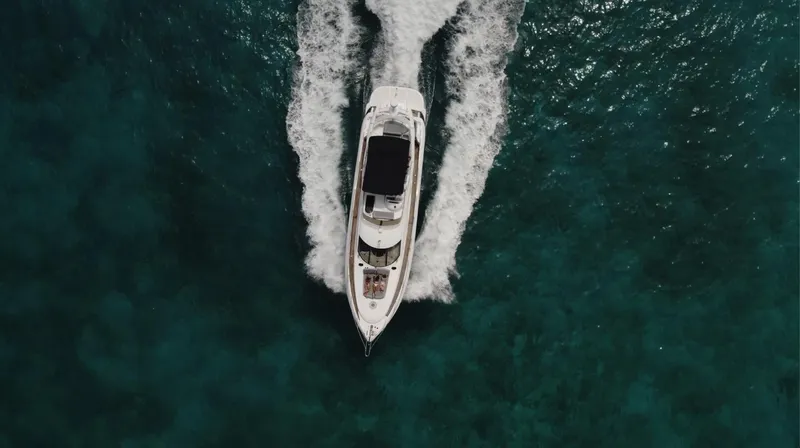 La More Yacht Photos Pics Aerial view of 2004 Sunseeker Manhattan 60 yacht cruising on clear blue water.