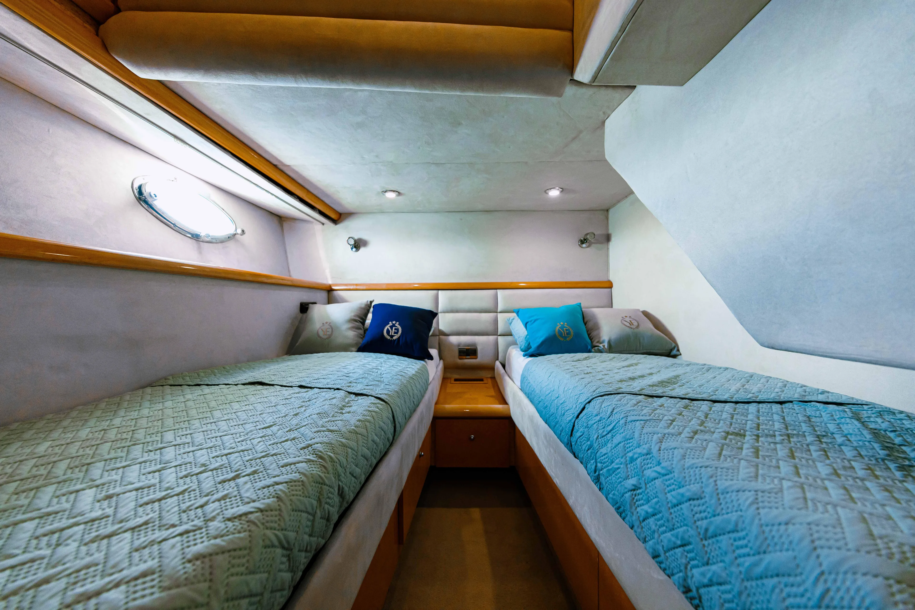 La More Yacht Photos Pics Twin cabin interior of 2004 Sunseeker Manhattan 60 yacht, featuring cozy bedding and ambient lighting.