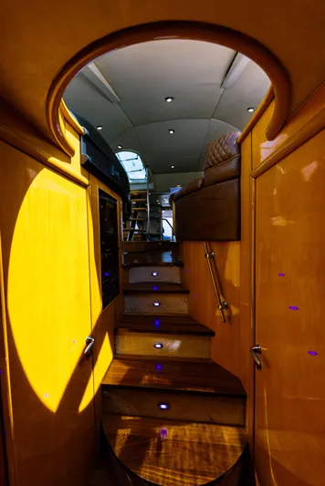 La More Yacht Photos Pics Interior staircase of 2004 Sunseeker Manhattan 60 yacht, featuring wooden steps and ambient lighting.