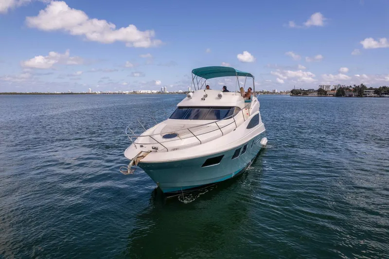 Yacht Photos Pics 2016 Silverton 43SB yacht cruising on calm waters under a clear blue sky.