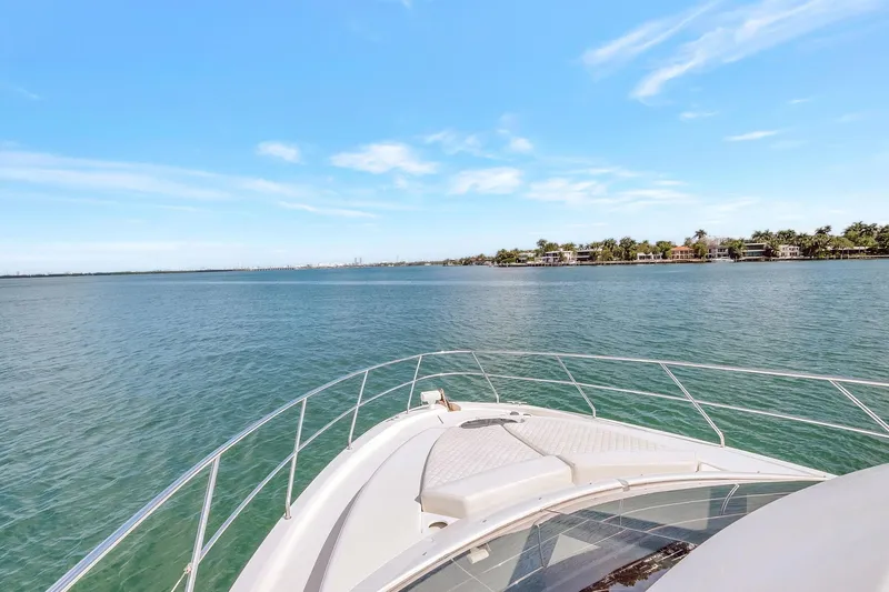  Yacht Photos Pics 2016 Silverton 43SB yacht cruising on a serene, sunny waterway.