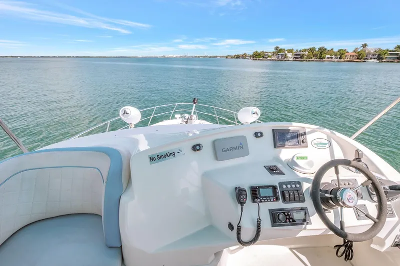 Yacht Photos Pics 2016 Silverton 43SB yacht helm with ocean view, featuring navigation equipment and steering wheel.