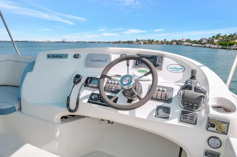  Yacht Photos Pics 2016 Silverton 43SB yacht helm with Garmin navigation, steering wheel, and control panel.