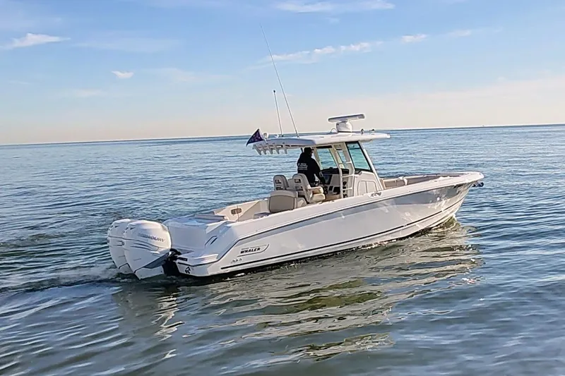  Yacht Photos Pics 2019 Boston Whaler 330 Outrage cruising on calm ocean waters.