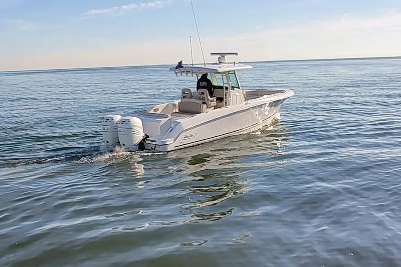  Yacht Photos Pics 2019 Boston Whaler 330 Outrage cruising on calm ocean waters.