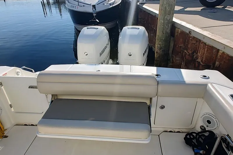  Yacht Photos Pics 2019 Boston Whaler 330 Outrage boat with twin Mercury engines at dock.