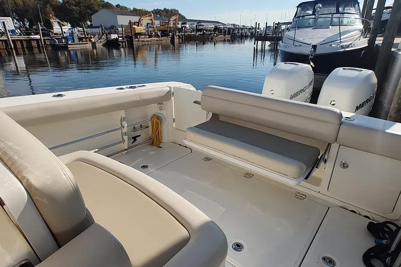  Yacht Photos Pics 2019 Boston Whaler 330 Outrage boat interior with seating and twin Mercury engines.