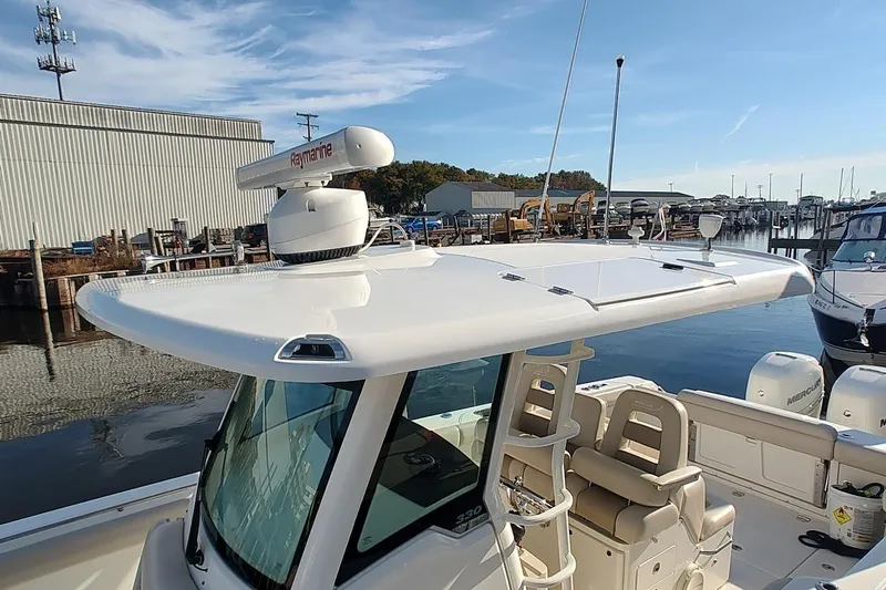  Yacht Photos Pics 2019 Boston Whaler 330 Outrage boat docked, featuring Raymarine radar and comfortable seating.