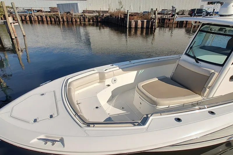 Yacht Photos Pics 2019 Boston Whaler 330 Outrage boat docked by calm waters.