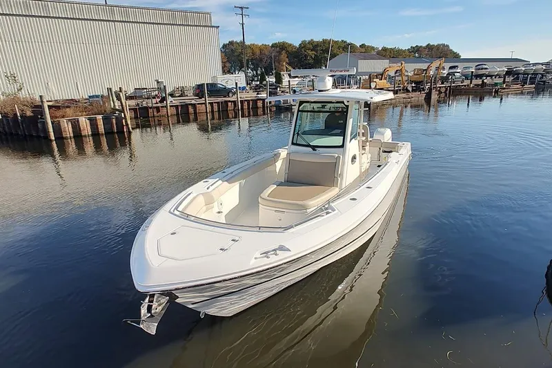  Yacht Photos Pics 2019 Boston Whaler 330 Outrage boat docked in a marina setting.