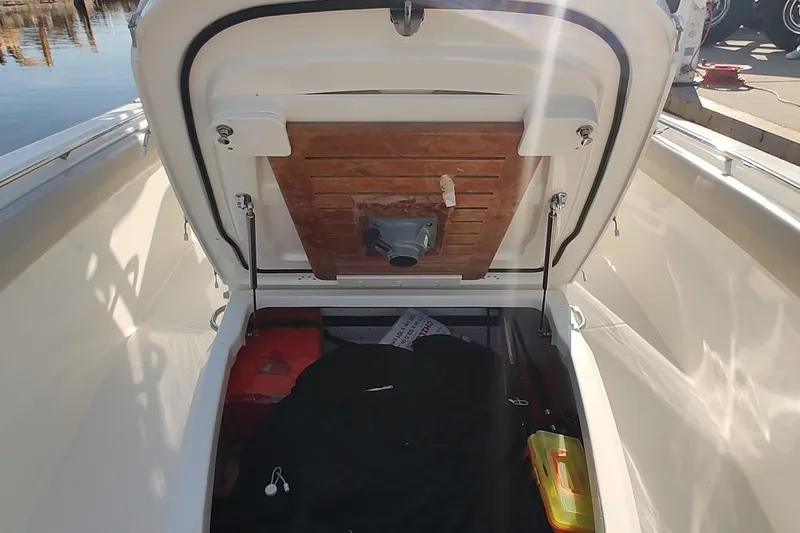  Yacht Photos Pics Open storage compartment on a 2019 Boston Whaler 330 Outrage boat, showing interior details.