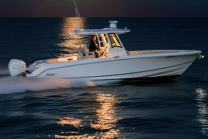  Yacht Photos Pics 2019 Boston Whaler 330 Outrage cruising at sunset on calm waters.