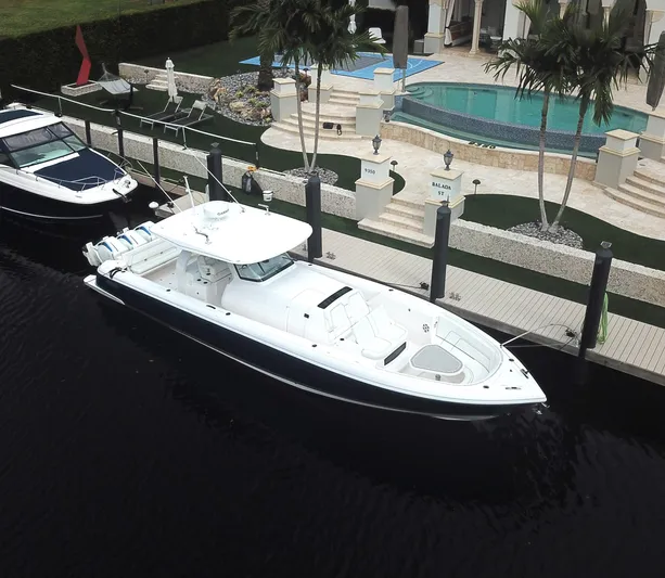  Yacht Photos Pics 2022 Intrepid 407 Panacea docked near luxury waterfront property.