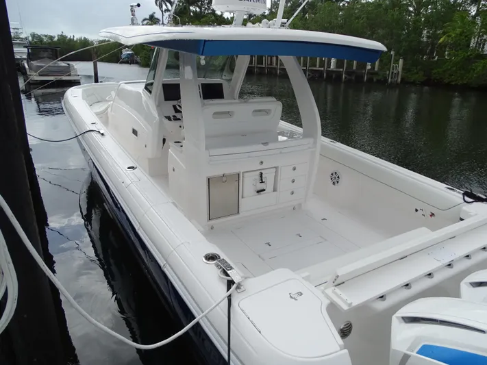  Yacht Photos Pics 2022 Intrepid 407 Panacea boat docked on calm water, featuring spacious deck and modern design.