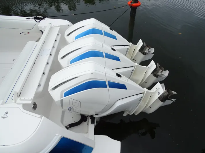  Yacht Photos Pics 2022 Intrepid 407 Panacea with triple outboard engines on calm water.