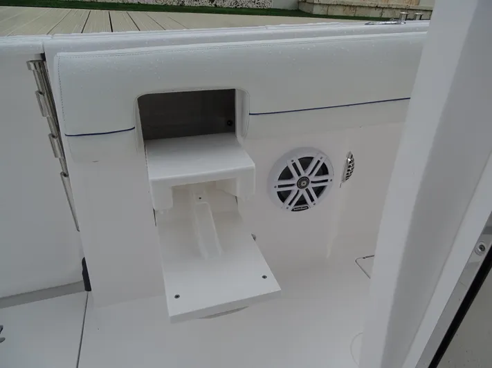  Yacht Photos Pics 2022 Intrepid 407 Panacea boat interior with speaker and storage compartment.