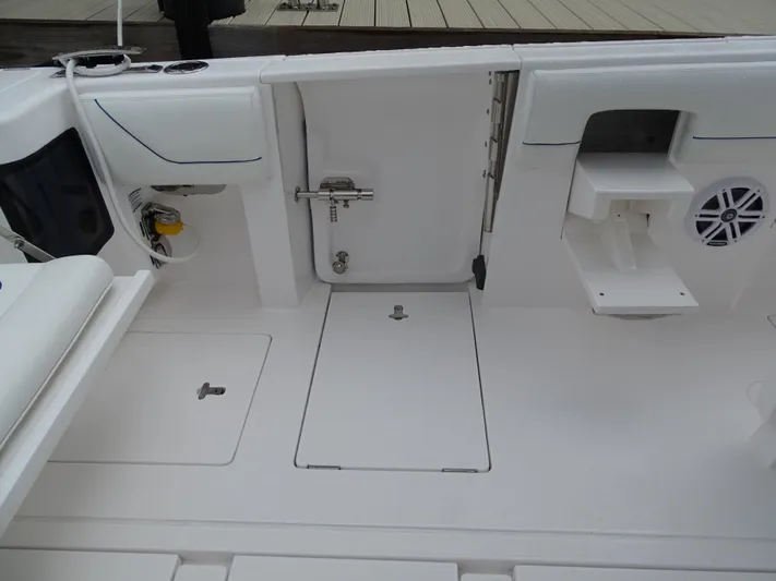  Yacht Photos Pics 2022 Intrepid 407 Panacea boat deck with storage compartments and seating area.