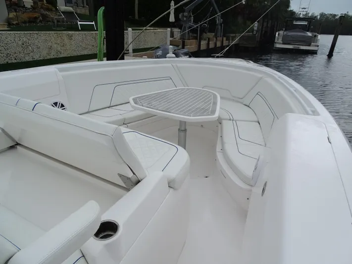  Yacht Photos Pics 2022 Intrepid 407 Panacea boat with spacious seating and table on deck.