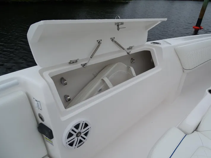  Yacht Photos Pics 2022 Intrepid 407 Panacea boat storage compartment with open lid and speaker.