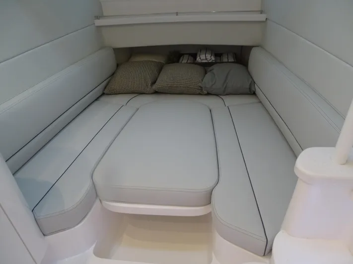  Yacht Photos Pics 2022 Intrepid 407 Panacea cabin interior with cushioned seating and pillows.
